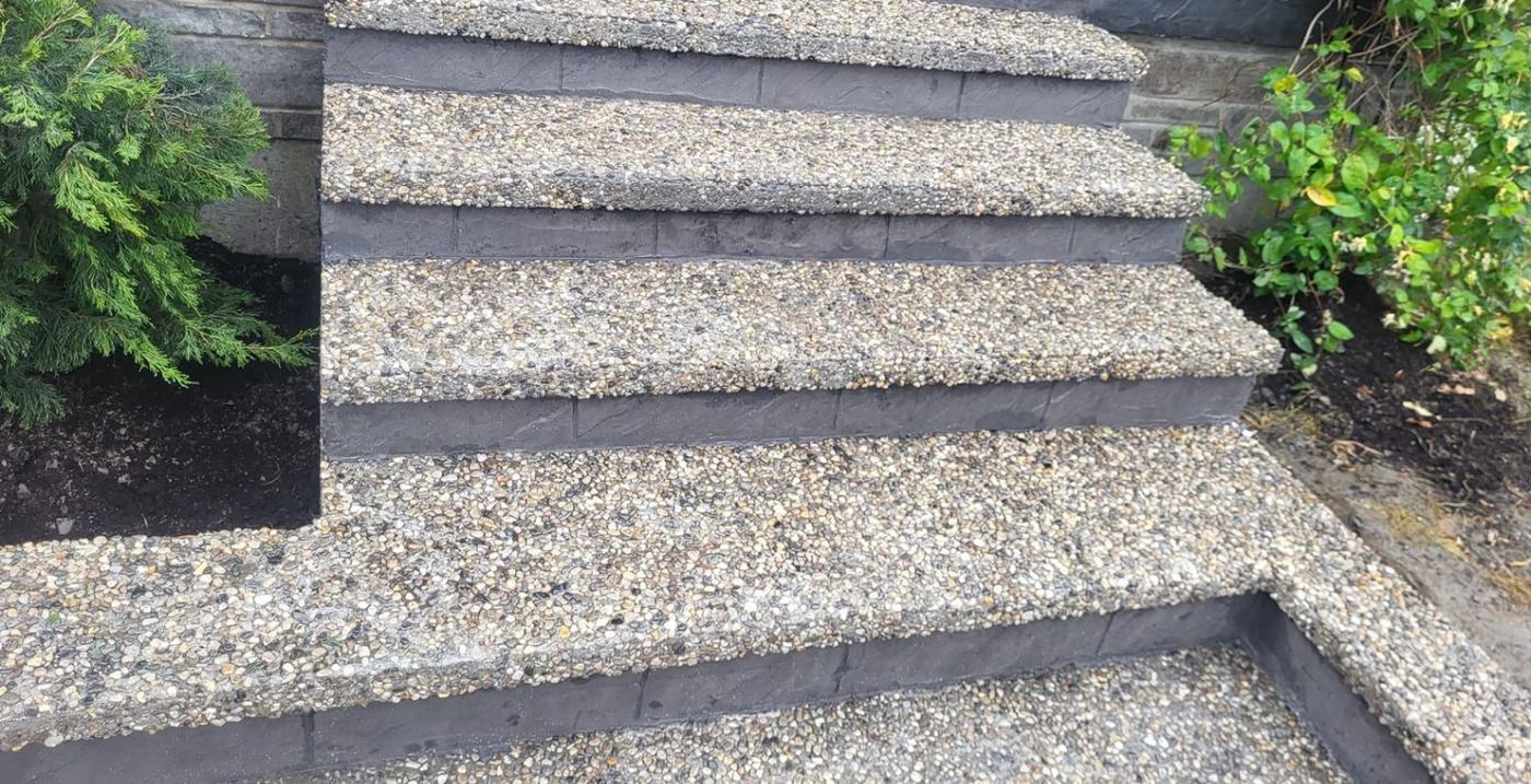 Exposed aggregate steps set between planted beds