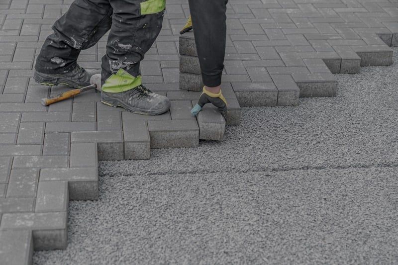 Interlocking paver steps being set by hand